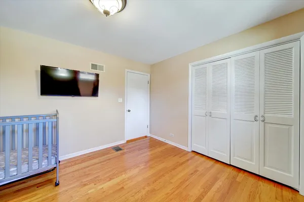 a view of a livingroom with wooden floor and a flat screen tv