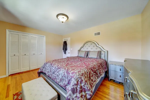 a bedroom with a bed and a dresser