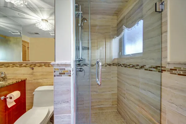 a bathroom with a shower and a sink