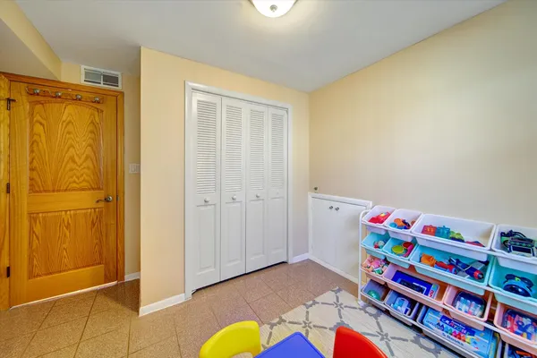 a room with toys and dresser with wooden floor