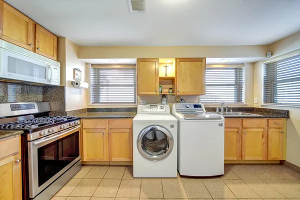 a kitchen with a stove top oven sink and cabinets