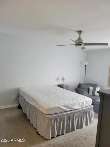 a bed sitting in a room next to a window