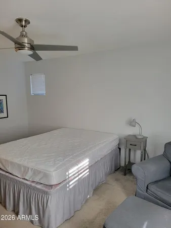 a bedroom with a bed and a couch