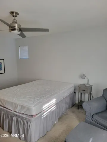 a bedroom with a bed and a couch