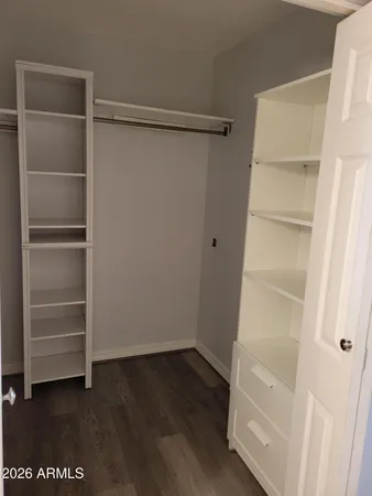 a view of walk in closet with empty racks