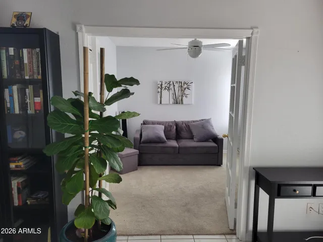 a living room with furniture and a potted plant
