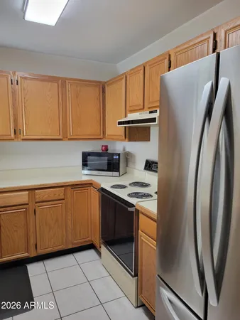 a kitchen with stainless steel appliances granite countertop a refrigerator sink and cabinets