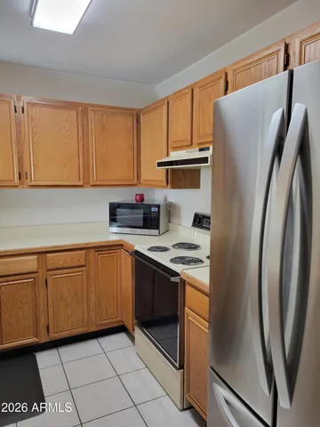 a kitchen with stainless steel appliances granite countertop a refrigerator sink and cabinets
