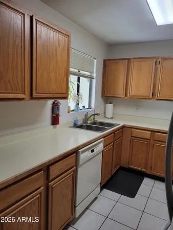 a kitchen with a sink cabinets and window