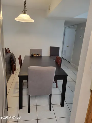 a view of a dining room with furniture and chandelier