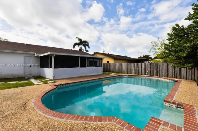 a view of a swimming pool with a yard