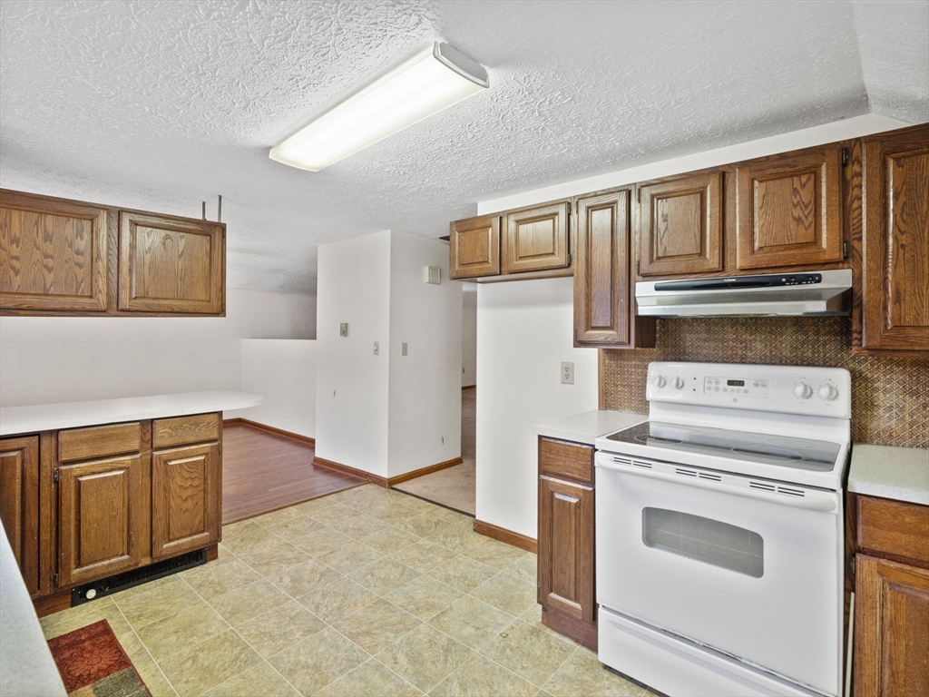 2154 Main Street Athol, MA 01331 - Photo 23 of 40 a kitchen with granite countertop cabinets and steel appliances