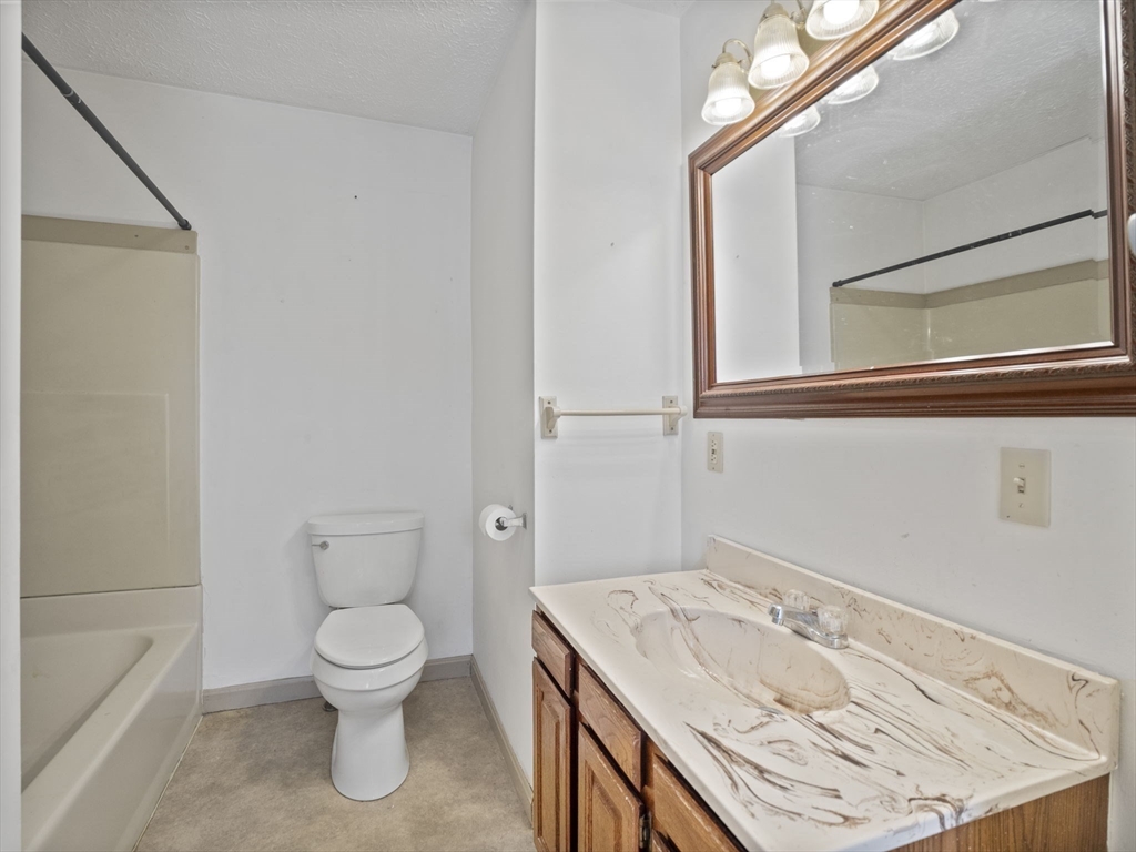 2154 Main Street Athol, MA 01331 - Photo 29 of 40 a bathroom with a sink a toilet and a mirror