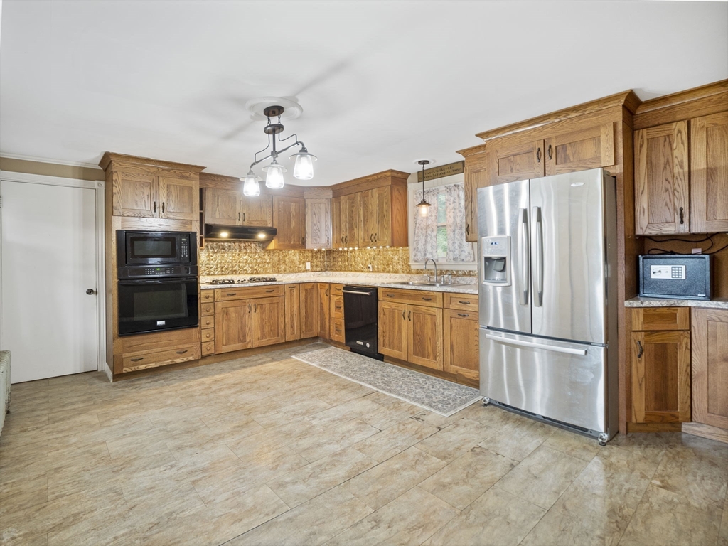 2154 Main Street Athol, MA 01331 - Photo 4 of 40 a kitchen with stainless steel appliances granite countertop a refrigerator oven a sink dishwasher and white cabinets next to a window