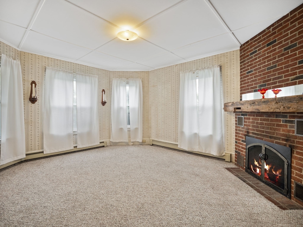 2154 Main Street Athol, MA 01331 - Photo 7 of 40 a view of an empty room with window and fire place