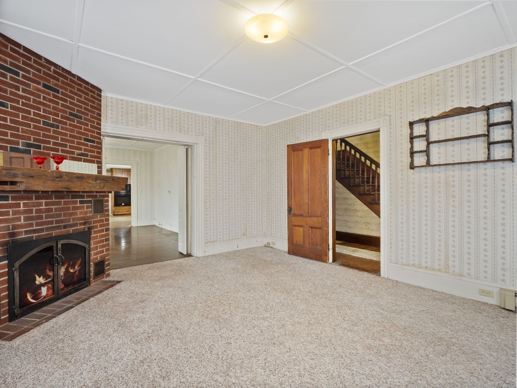 2154 Main Street Athol, MA 01331 - Photo 8 of 40 an empty room with furniture and a fireplace