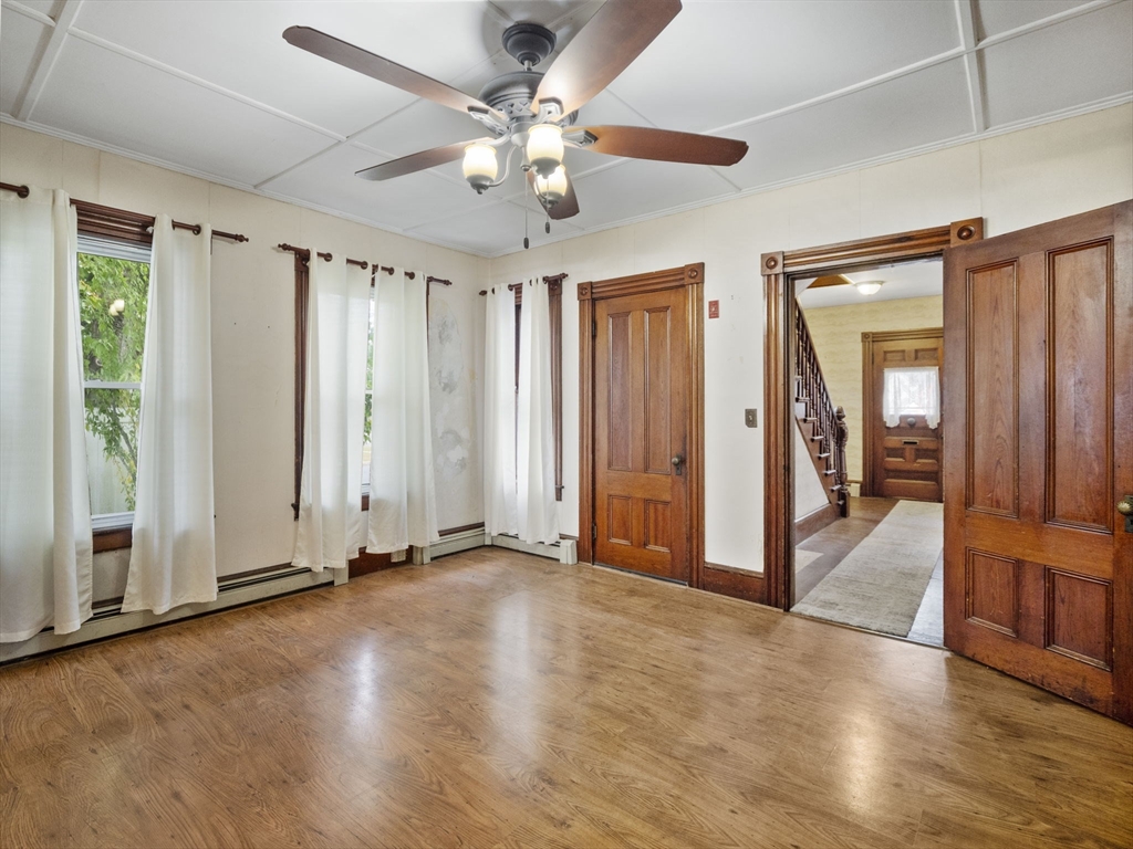 2154 Main Street Athol, MA 01331 - Photo 9 of 40 an empty room with wooden floor fan and windows
