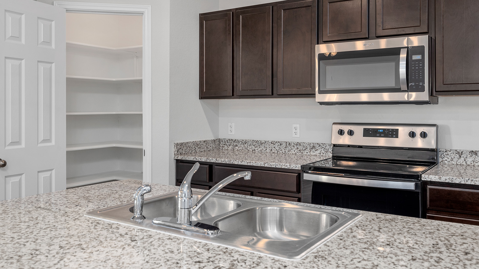 1417 Victory Rnch Trail Killeen, TX 76549 - Photo 4 of 22 Modern kitchen with generous counter space, a double basin sink, and ample pantry storage.