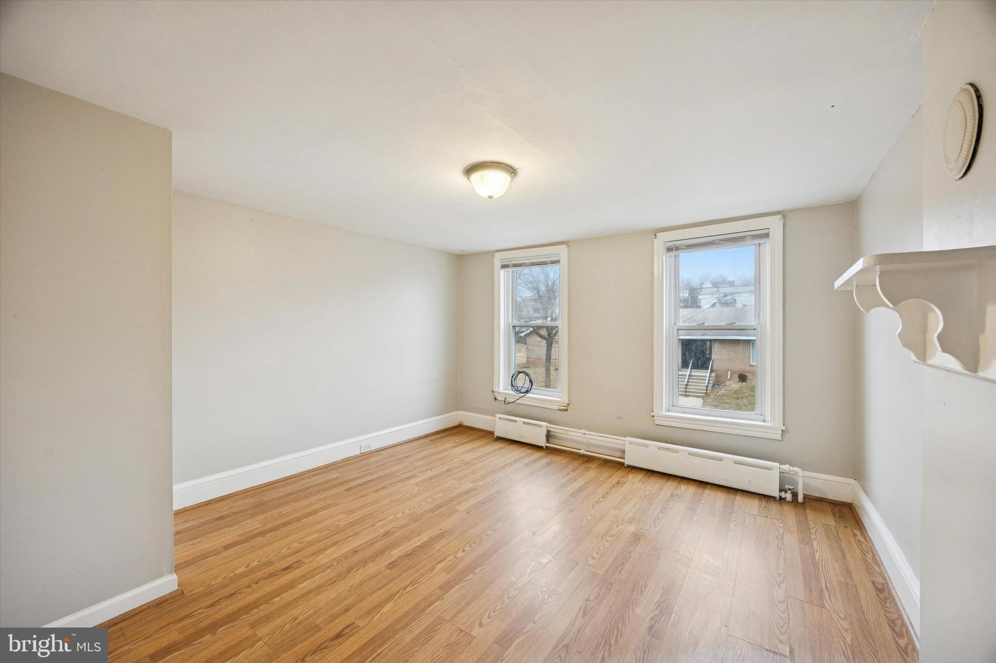 544 Walnut Street Pottstown, PA 19464 - Photo 12 of 14 an empty room with wooden floor and windows