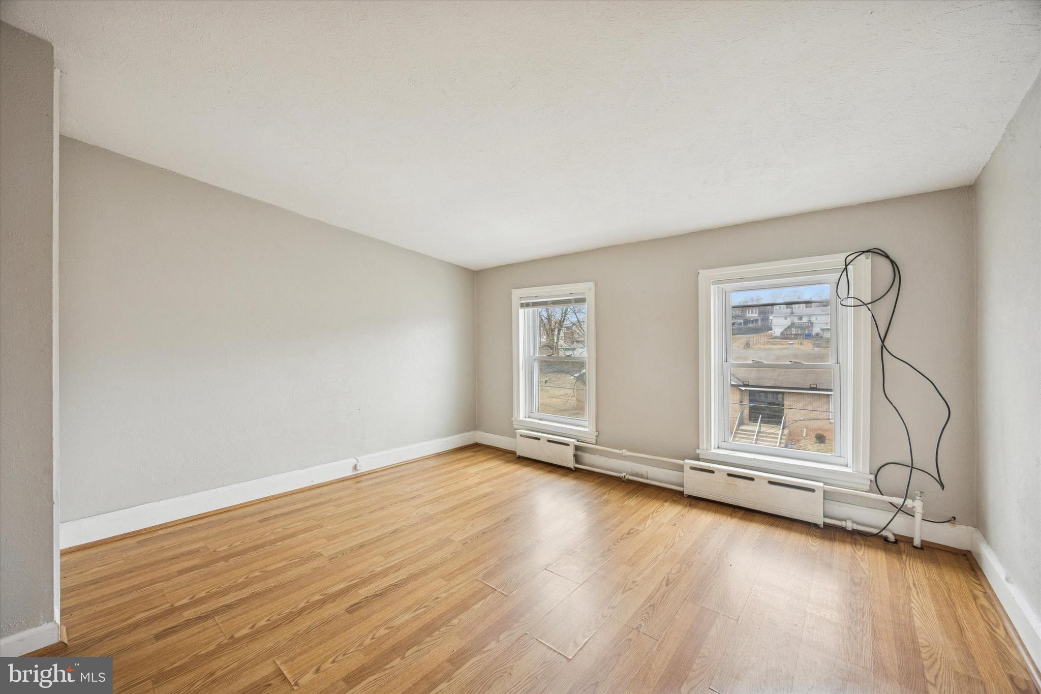 544 Walnut Street Pottstown, PA 19464 - Photo 7 of 14 an empty room with wooden floor and windows