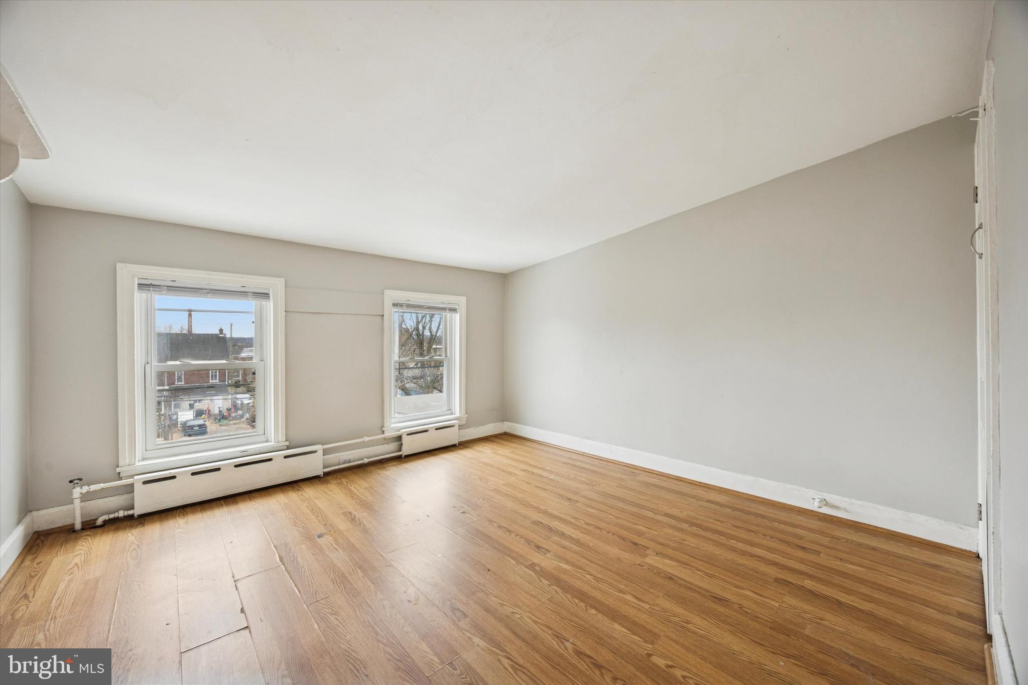 544 Walnut Street Pottstown, PA 19464 - Photo 8 of 14 an empty room with wooden floor and windows