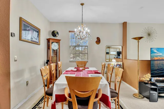 a view of a dining room with furniture and chandelier