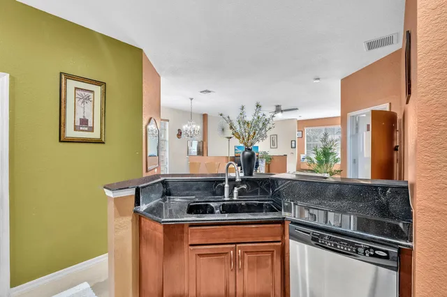 a kitchen with stainless steel appliances granite countertop a sink stove and cabinets