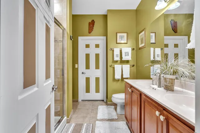 a spacious bathroom with a double vanity sink a mirror and a shower