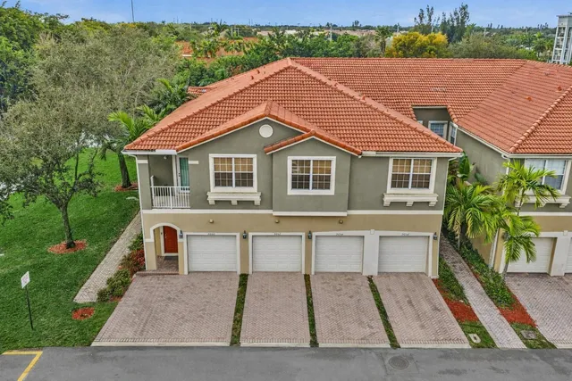 a view of a garden with large trees