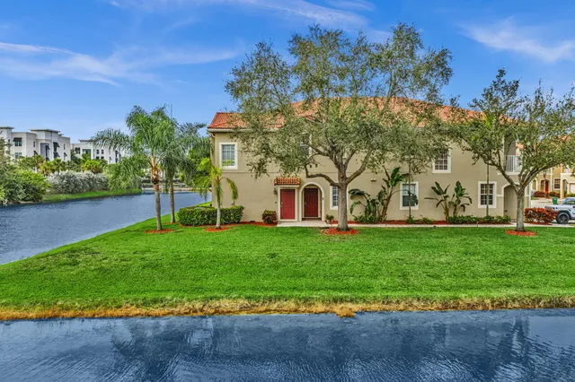 an aerial view of a house with a garden and lake view