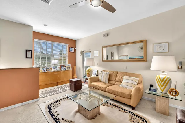 a living room with furniture and a lamp