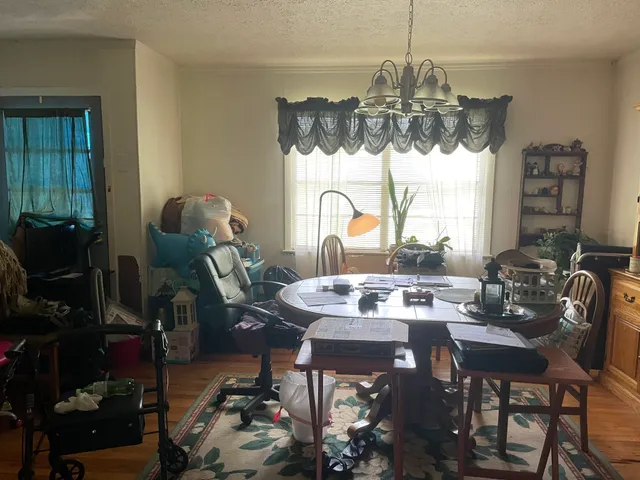 a view of a dining room with furniture and chandelier