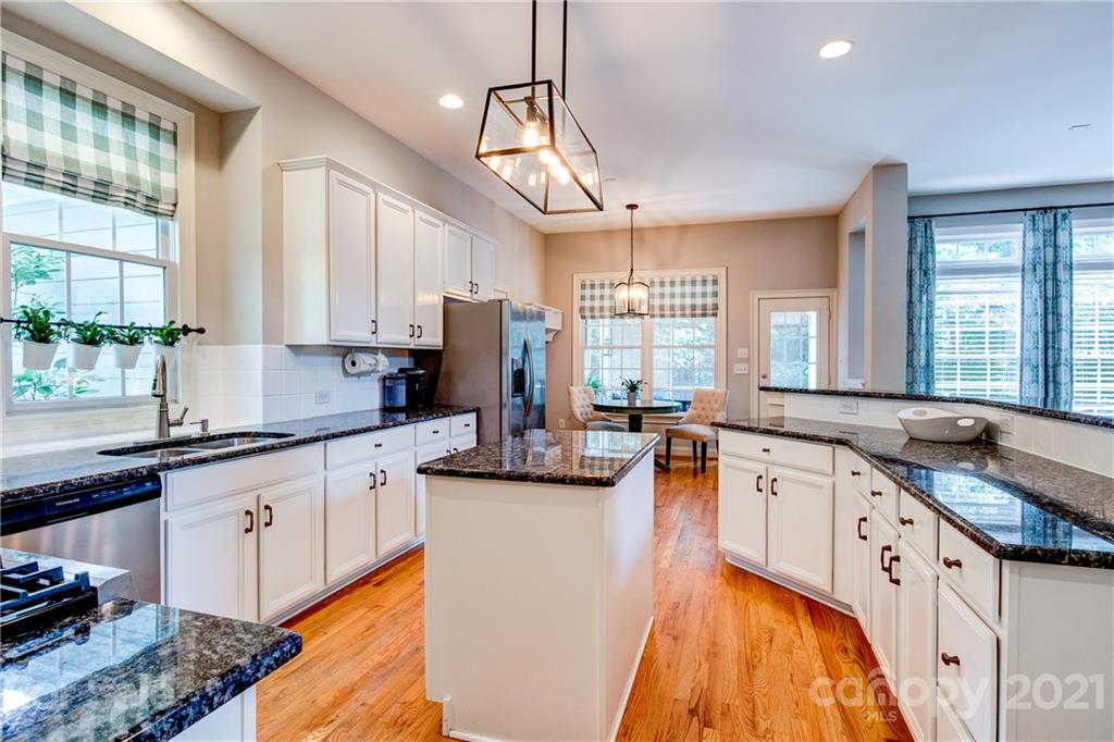7155 Michael Scott Crossing Fort Mill, SC 29708 - Photo 14 of 41 a large kitchen with stainless steel appliances granite countertop a sink and cabinets