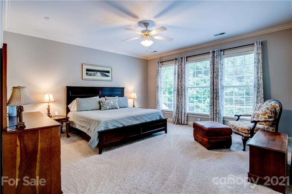 7155 Michael Scott Crossing Fort Mill, SC 29708 - Photo 18 of 41 a bedroom with a bed couch and window