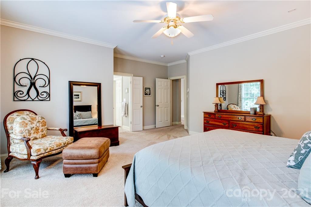 7155 Michael Scott Crossing Fort Mill, SC 29708 - Photo 19 of 41 a bedroom with a bed and a chandelier