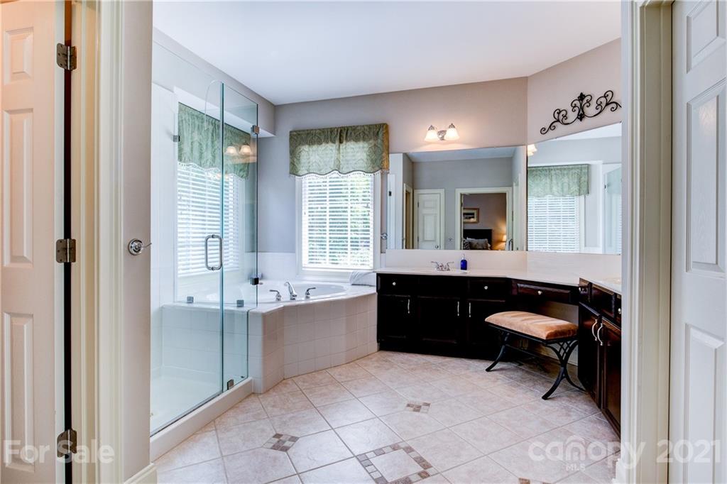 7155 Michael Scott Crossing Fort Mill, SC 29708 - Photo 21 of 41 a bathroom with a tub sink and mirror
