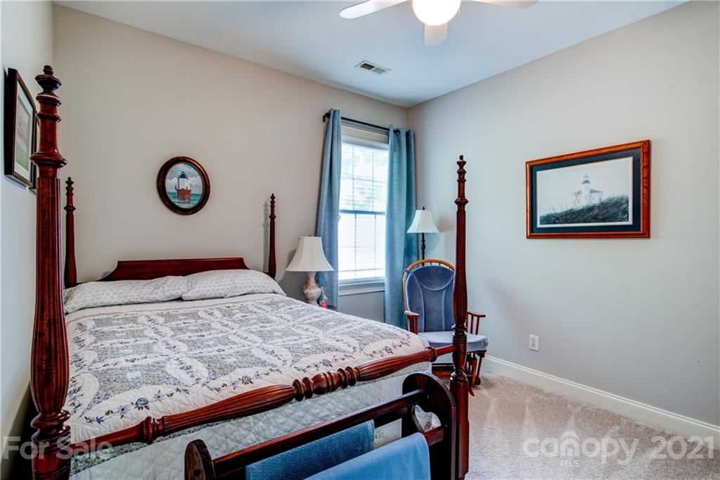 7155 Michael Scott Crossing Fort Mill, SC 29708 - Photo 23 of 41 a bedroom with a bed and a chandelier