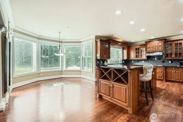 a view of a kitchen with furniture and wooden floor