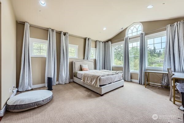 16925 Southeast 224th Street Kent, WA 98042 - Photo 14 of 21 a spacious bedroom with a bed and a chair