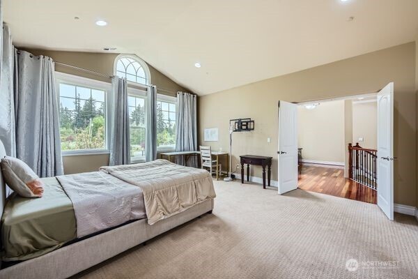 16925 Southeast 224th Street Kent, WA 98042 - Photo 15 of 21 a bedroom with a bed and a chandelier