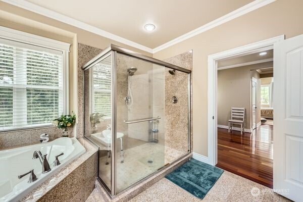 16925 Southeast 224th Street Kent, WA 98042 - Photo 17 of 21 a bathroom with a tub a window and a glass door shower