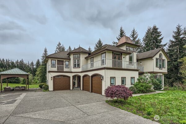 16925 Southeast 224th Street Kent, WA 98042 - Photo 2 of 21 a front view of a house with garden