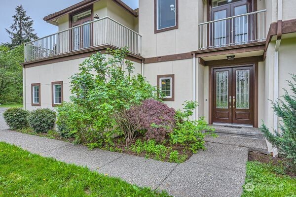 16925 Southeast 224th Street Kent, WA 98042 - Photo 4 of 21 a view of a house with potted plants and a yard in front of it