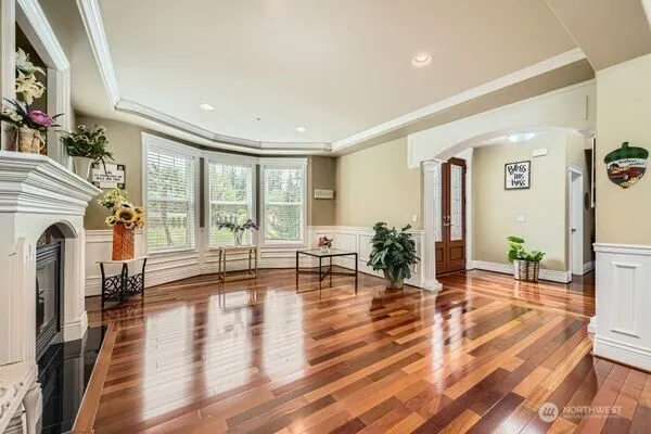 a living room with fireplace furniture and a wooden floor