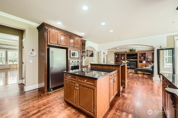16925 Southeast 224th Street Kent, WA 98042 - Photo 9 of 21 a kitchen with stainless steel appliances granite countertop a stove and a refrigerator
