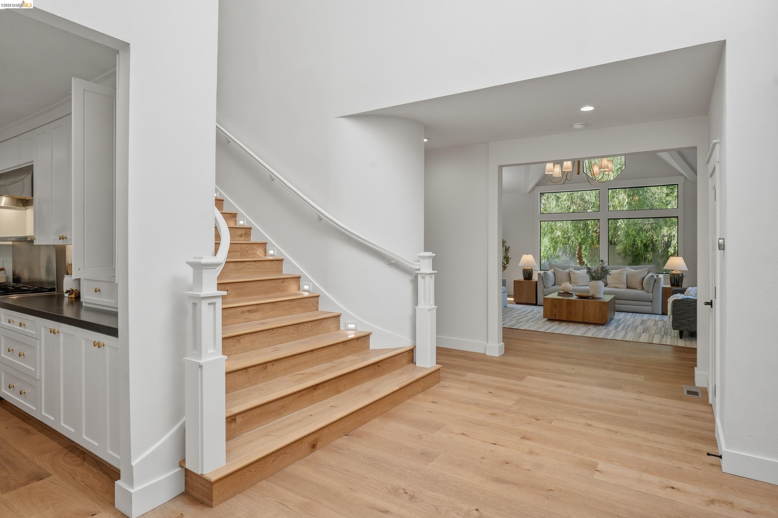 4120 Happy Valley Road Lafayette, CA 94549 - Photo 7 of 33 Light wood-finish flooring throughout the entry, featuring a curved staircase with white risers and wood treads