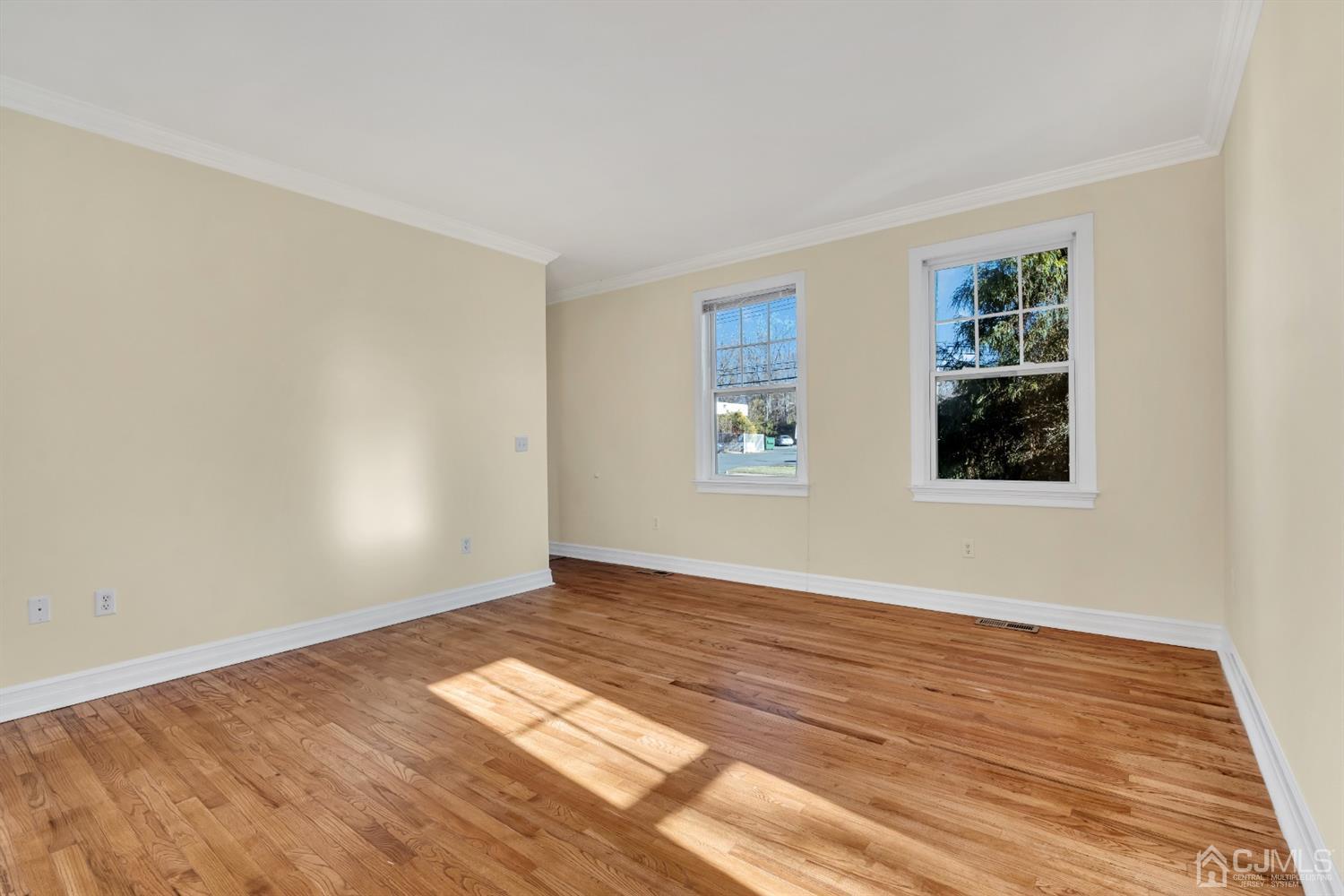 660 Ridge Road Monmouth Junction, NJ 08852 - Photo 11 of 52 a view of an empty room with wooden floor and a window