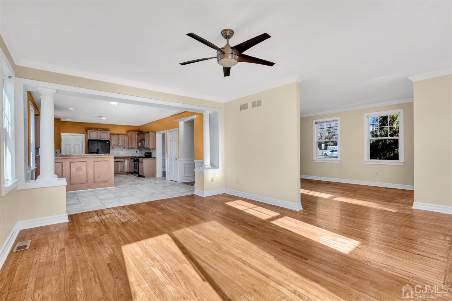660 Ridge Road Monmouth Junction, NJ 08852 - Photo 13 of 52 a view of a livingroom with a hardwood floor and a ceiling fan