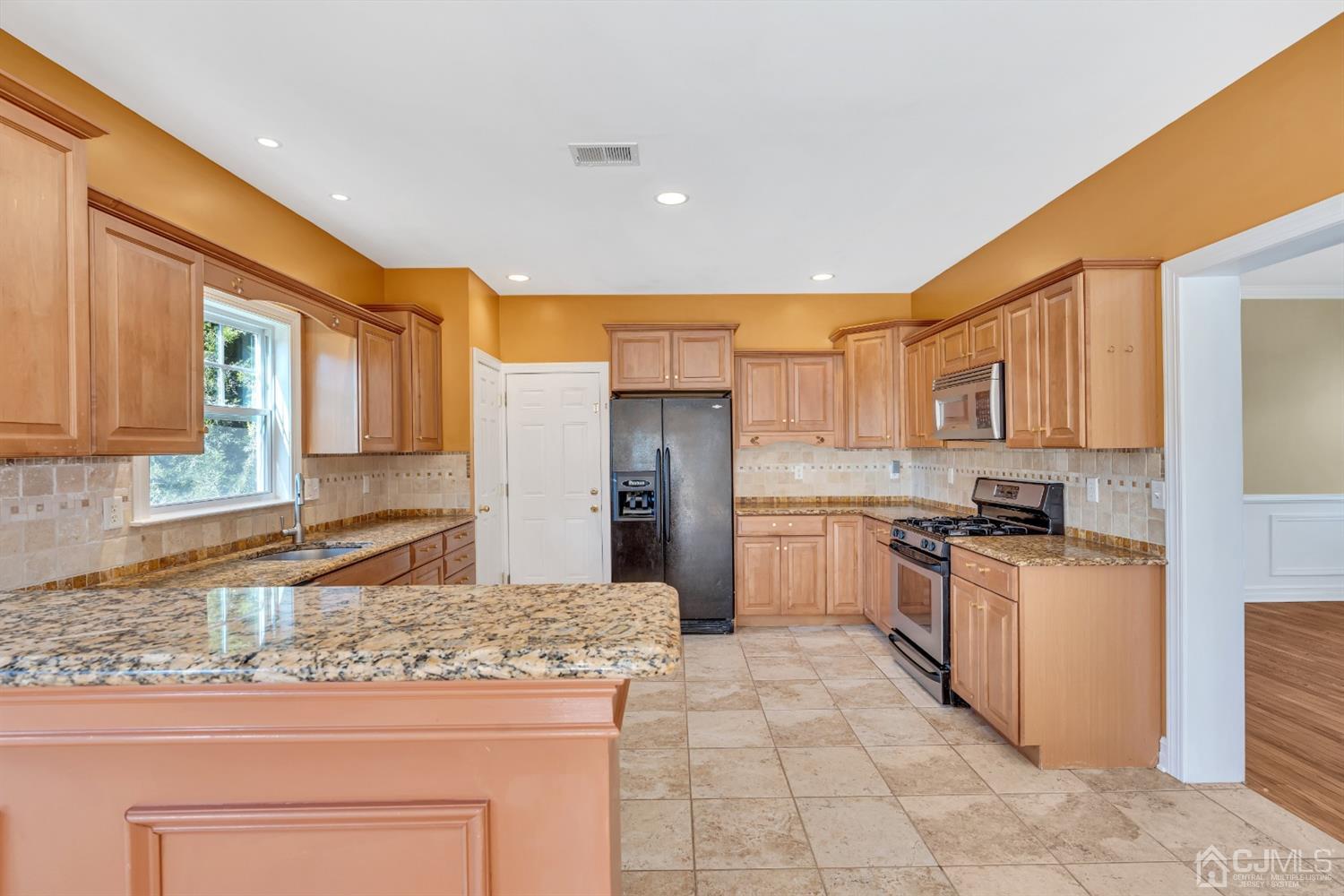 660 Ridge Road Monmouth Junction, NJ 08852 - Photo 17 of 52 a kitchen with stainless steel appliances granite countertop a stove a sink and a refrigerator