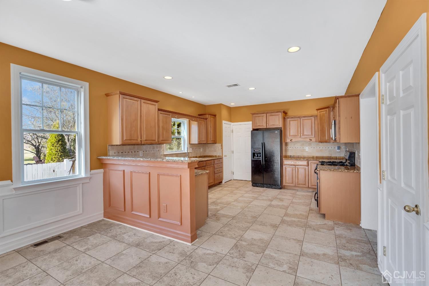 660 Ridge Road Monmouth Junction, NJ 08852 - Photo 18 of 52 a kitchen with granite countertop a refrigerator and cabinets